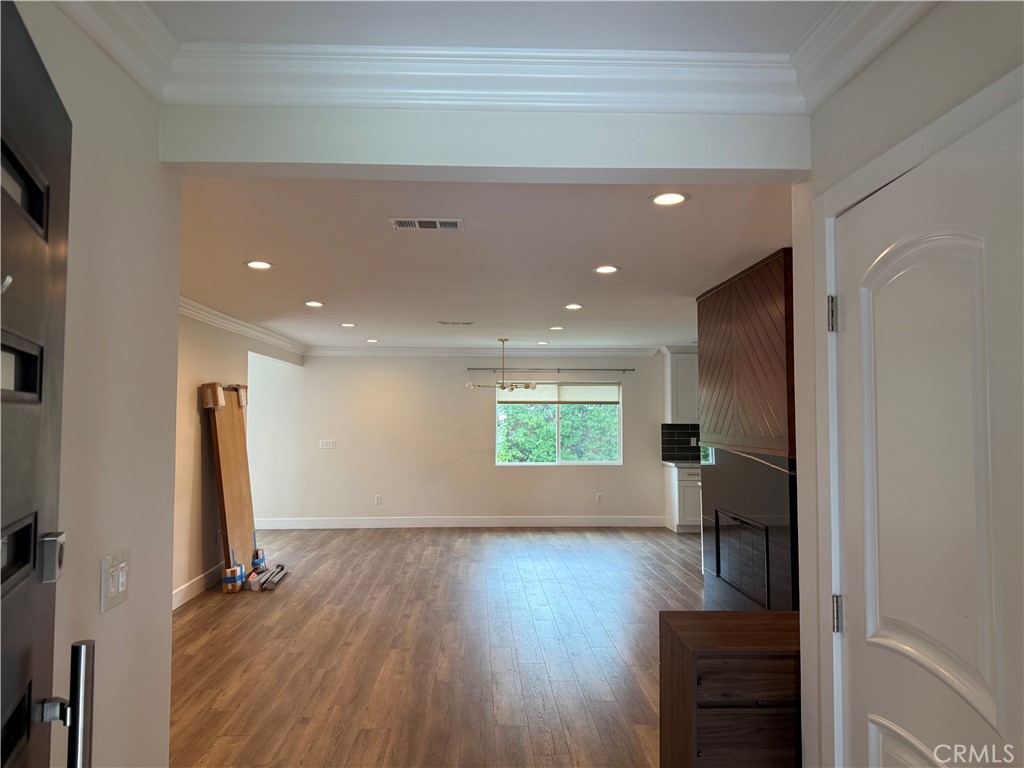 7459 Ruffner Avenue Van Nuys, CA 91406 - Photo 5 of 21 a view of an empty room with wooden floor and a window