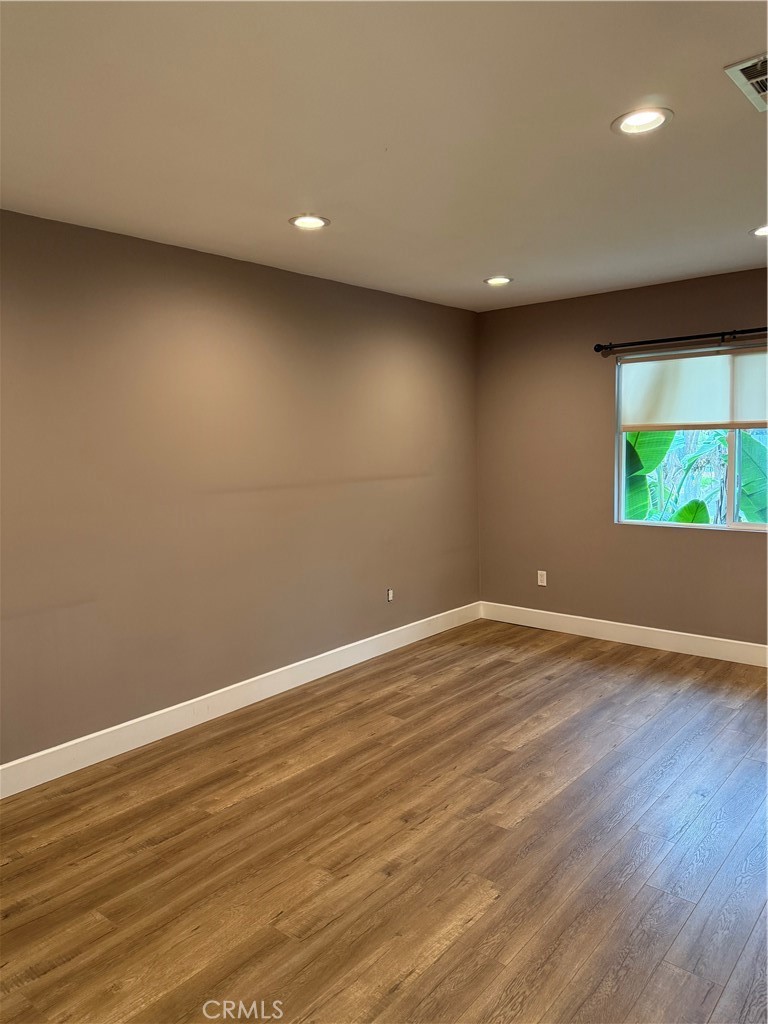 7459 Ruffner Avenue Van Nuys, CA 91406 - Photo 5 of 20 a view of empty room with wooden floor and fan