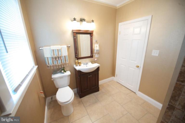 1808 Kinship Road Dundalk, MD 21222 - Photo 13 of 19 a bathroom with a toilet sink and mirror