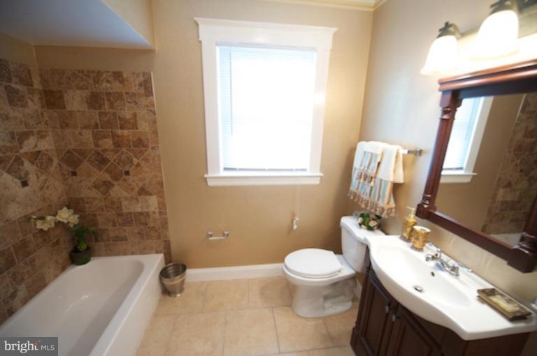 1808 Kinship Road Dundalk, MD 21222 - Photo 14 of 19 a bathroom with a sink toilet and shower