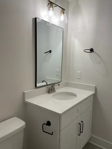 a bathroom with a double vanity sink mirror and