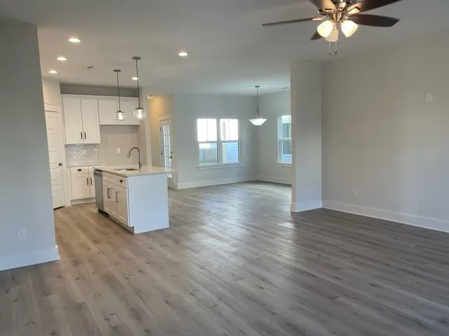 a view of kitchen with sink and wooden floor