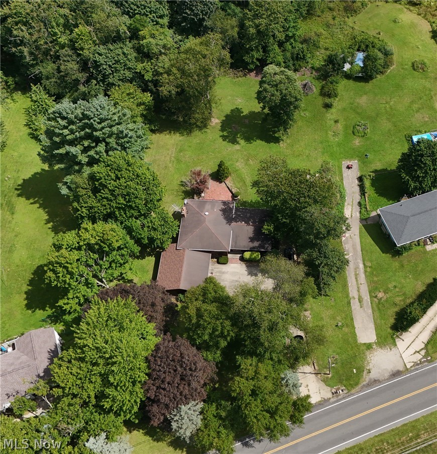 6451 Kungle Road Clinton, OH 44216 - Photo 2 of 34 Aerial view showcasing a substantial residence nestled on expansive grounds with mature landscaping, including established trees and manicured lawn