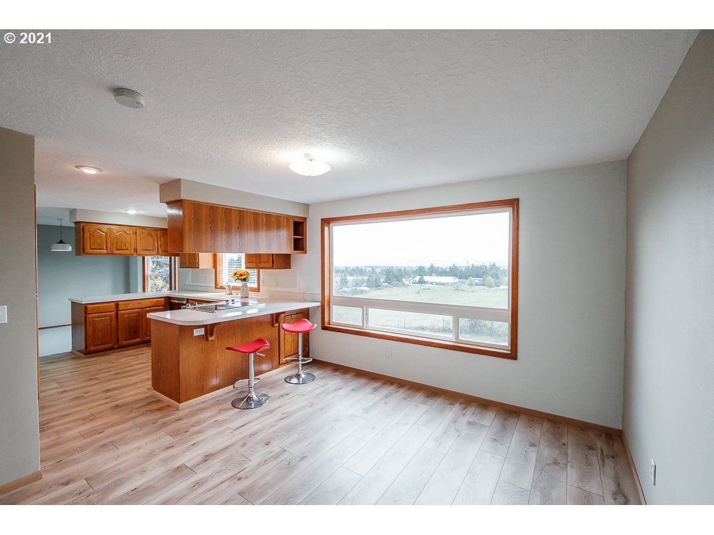 15305 Oakdale Road Dallas, OR 97338 - Photo 12 of 32 a open kitchen with granite countertop a stove top oven a sink and a granite counter top