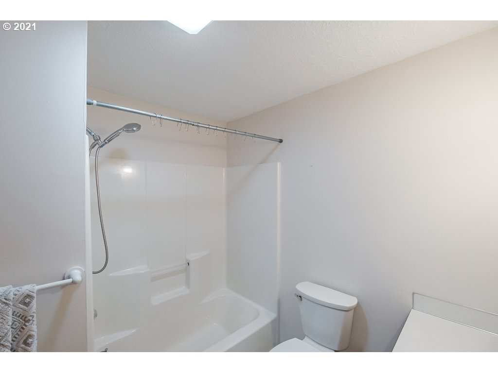 15305 Oakdale Road Dallas, OR 97338 - Photo 21 of 32 a bathroom with a shower and a toilet