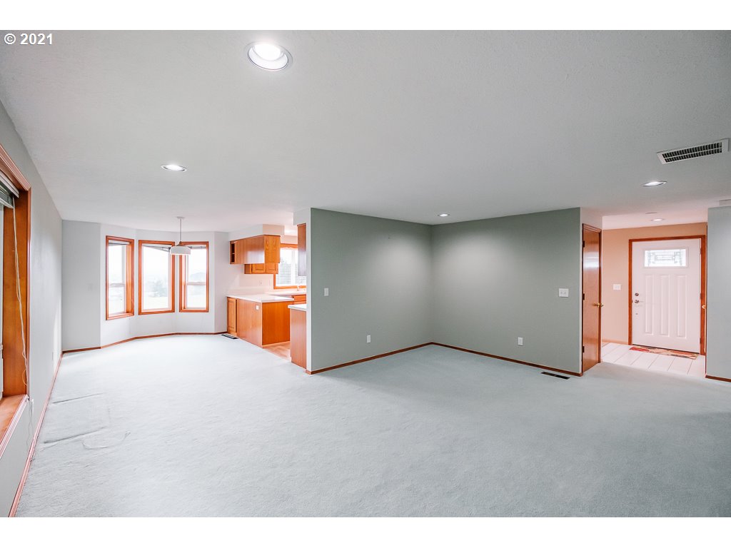 15305 Oakdale Road Dallas, OR 97338 - Photo 5 of 32 a view of an empty room with window and wooden floor