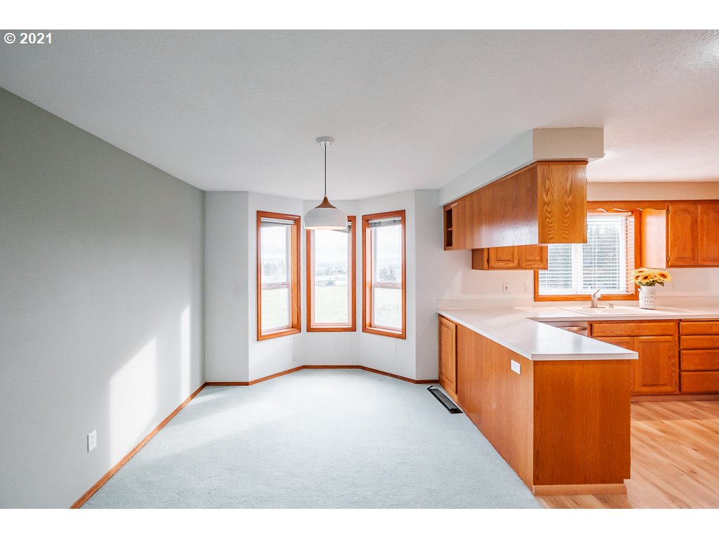 15305 Oakdale Road Dallas, OR 97338 - Photo 6 of 32 a large kitchen with stainless steel appliances granite countertop a large counter top a stove and a sink
