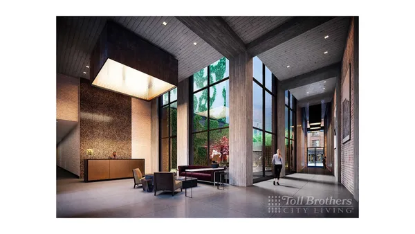 a living room with couches and a kitchen view with wooden floor