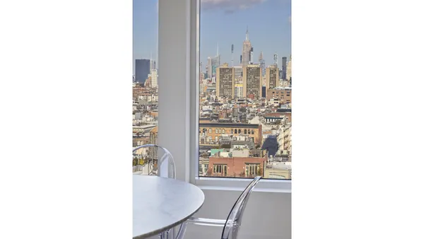 a view of a dining room with furniture and window