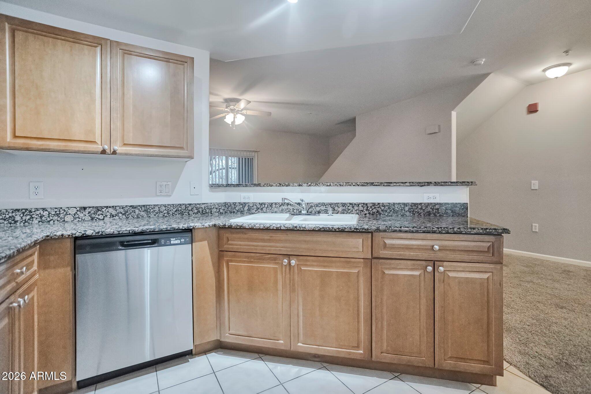 1920 East Bell Road, Unit 1006 Phoenix, AZ 85022 - Photo 13 of 25 a kitchen with granite countertop white cabinets and a sink