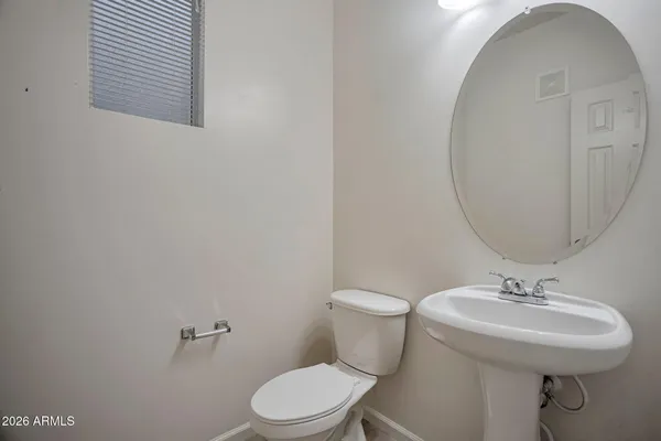 a white toilet sitting next to a bathroom sink