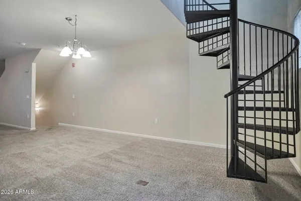 a view of a chandelier fan and entryway