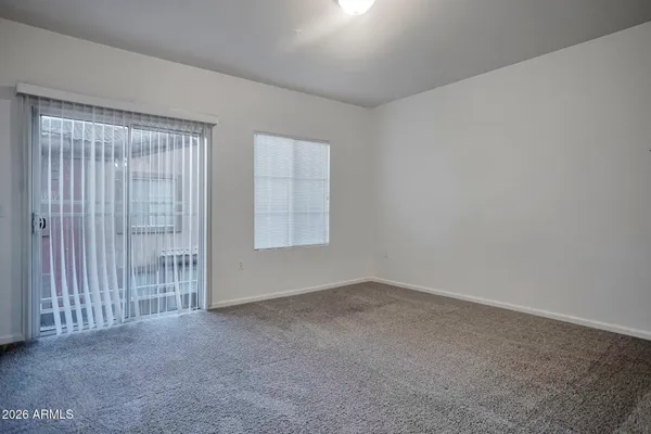 a view of an empty room and closet area