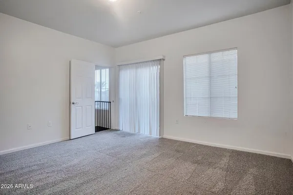an empty room with windows and closet