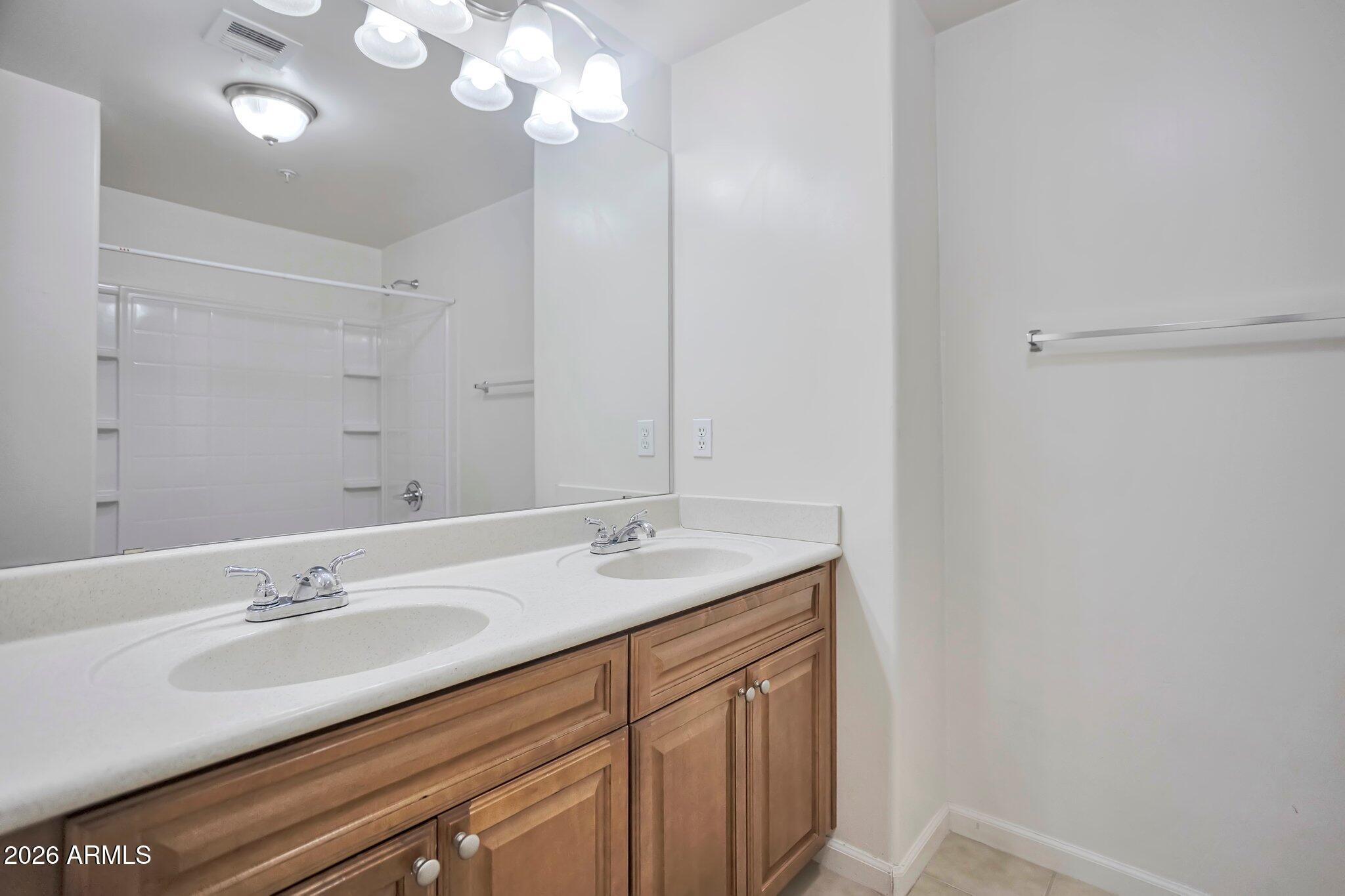 1920 East Bell Road, Unit 1006 Phoenix, AZ 85022 - Photo 22 of 25 a bathroom with a sink double vanity and a mirror