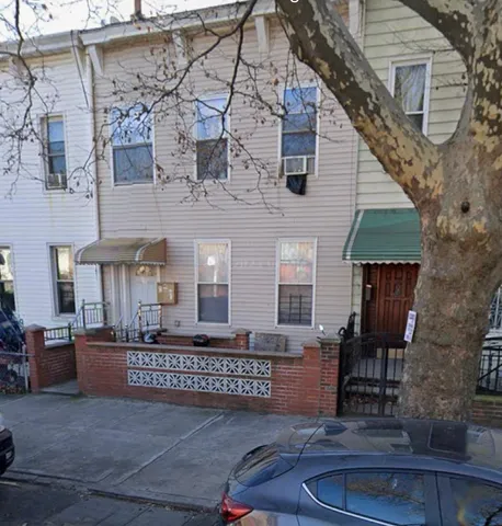 a view of a brick house with many windows