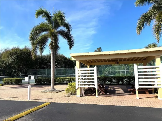 a view of a patio with a table and chairs under an umbrella