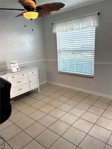 a bathroom with a window vanity and mirror