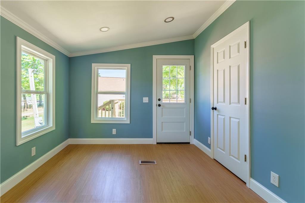 1412 Floyd Circle Gainesville, GA 30507 - Photo 16 of 38 a view of an empty room with glass door and wooden floor