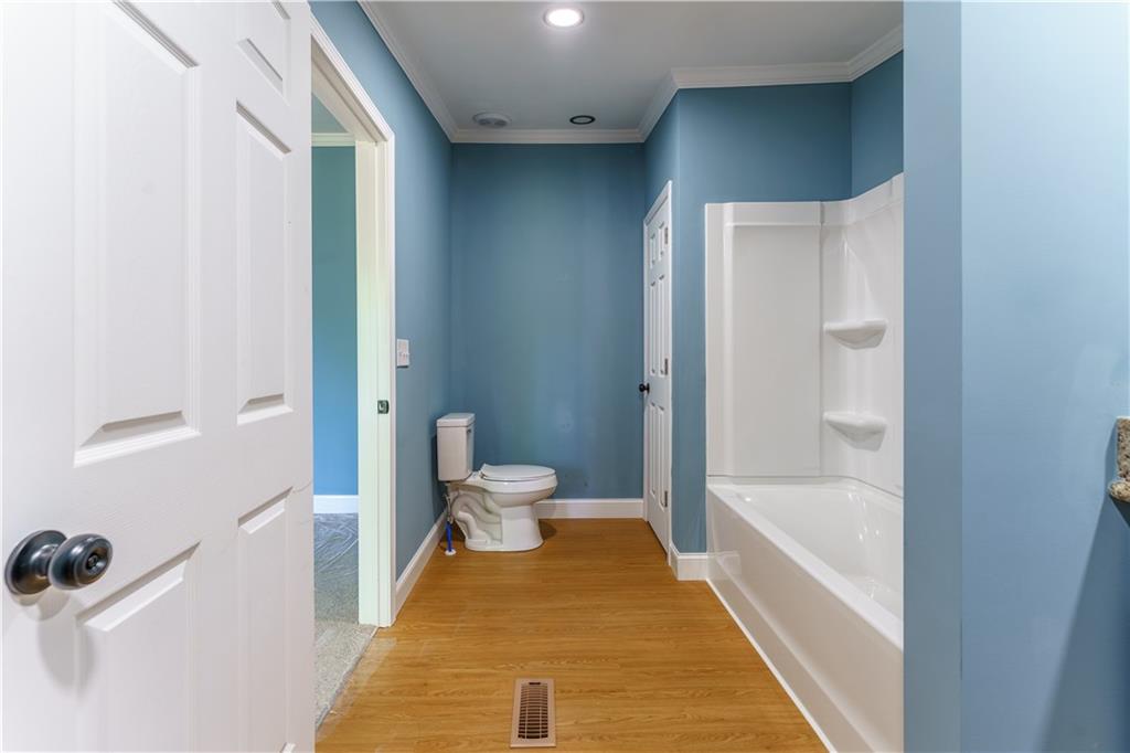 1412 Floyd Circle Gainesville, GA 30507 - Photo 19 of 38 a bathroom with a tub and toilet