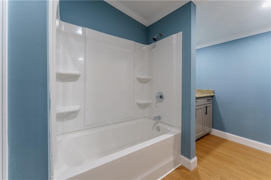 1412 Floyd Circle Gainesville, GA 30507 - Photo 20 of 38 a bathroom with a bathtub and a shower