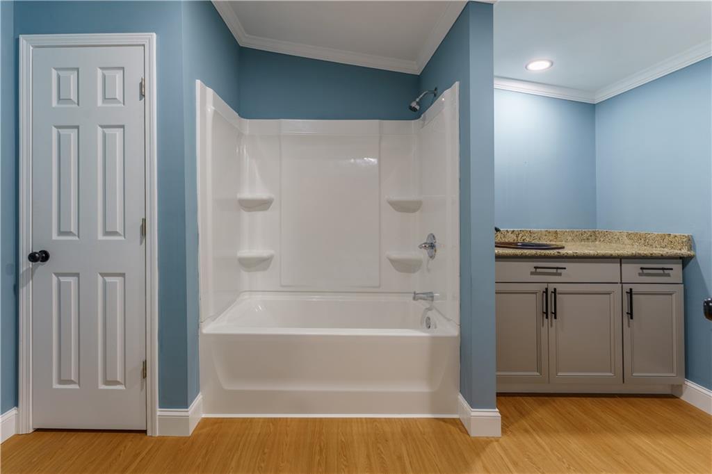 1412 Floyd Circle Gainesville, GA 30507 - Photo 21 of 38 a bathroom with a tub and shower