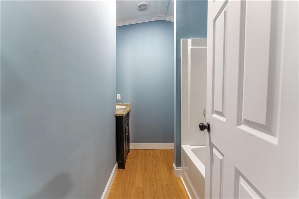 1412 Floyd Circle Gainesville, GA 30507 - Photo 26 of 38 a view of a hallway with wooden floor and staircase