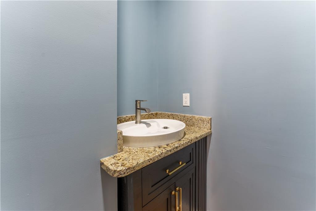 1412 Floyd Circle Gainesville, GA 30507 - Photo 27 of 38 a bathroom with a granite countertop sink and a mirror