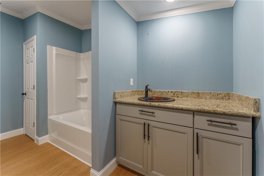 1412 Floyd Circle Gainesville, GA 30507 - Photo 28 of 38 a bathroom with a granite countertop sink and a mirror
