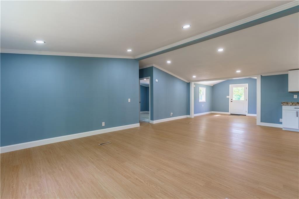 1412 Floyd Circle Gainesville, GA 30507 - Photo 10 of 38 a view of an empty room with wooden floor and a window