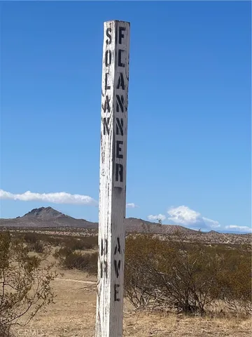 a view of a yard with a mountain