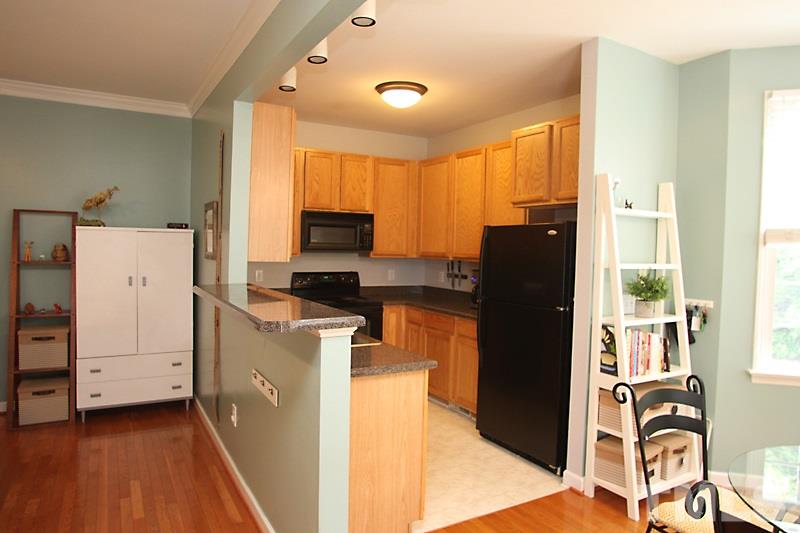 5430 Goldenglow Way Raleigh, NC 27606 - Photo 5 of 13 a kitchen with a refrigerator and a stove