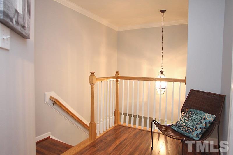 5430 Goldenglow Way Raleigh, NC 27606 - Photo 6 of 13 a view of a hallway with wooden floor and stairs