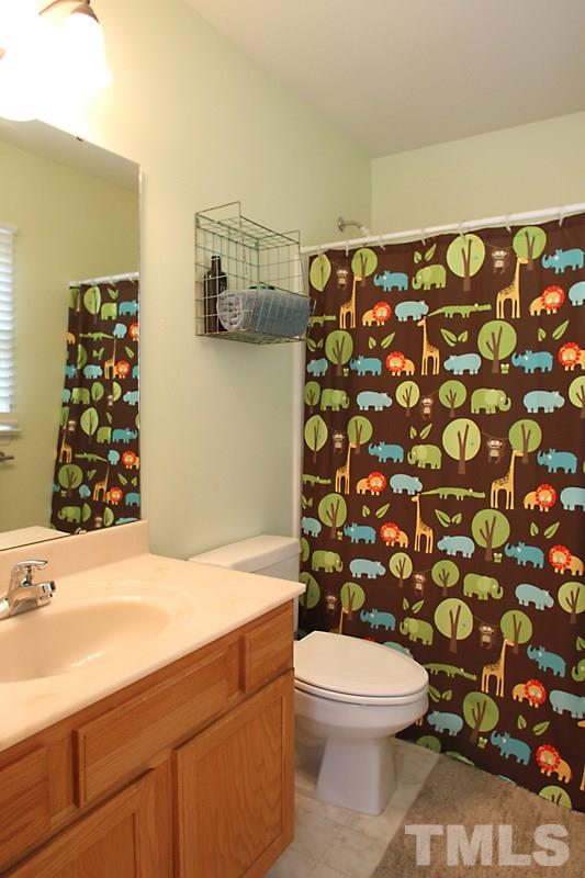 5430 Goldenglow Way Raleigh, NC 27606 - Photo 8 of 13 a bathroom with a sink toilet and shower