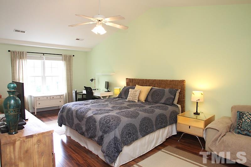 5430 Goldenglow Way Raleigh, NC 27606 - Photo 9 of 13 a bedroom with a bed and wooden floor