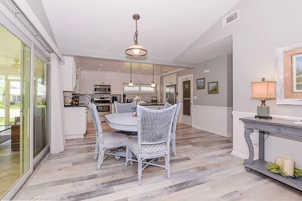 a view of a dining room with furniture window and wooden floor