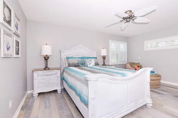 a bedroom with a bed and a chandelier