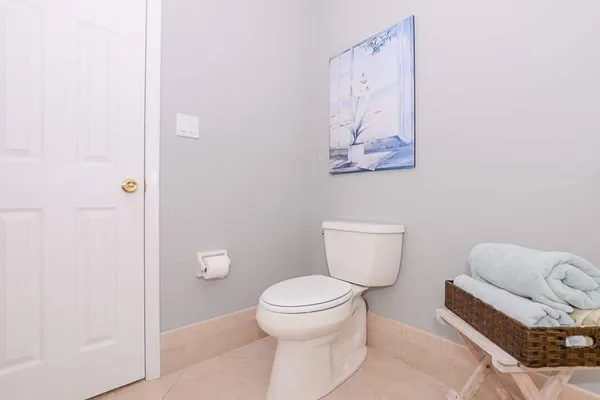 a white toilet sitting next to a bathroom sink
