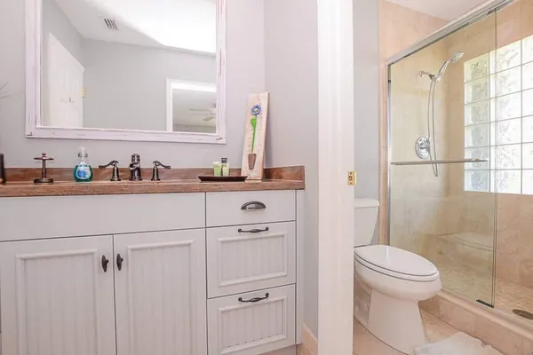 a white toilet sitting next to a shower