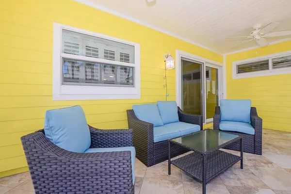 a balcony with furniture and a floor to ceiling window