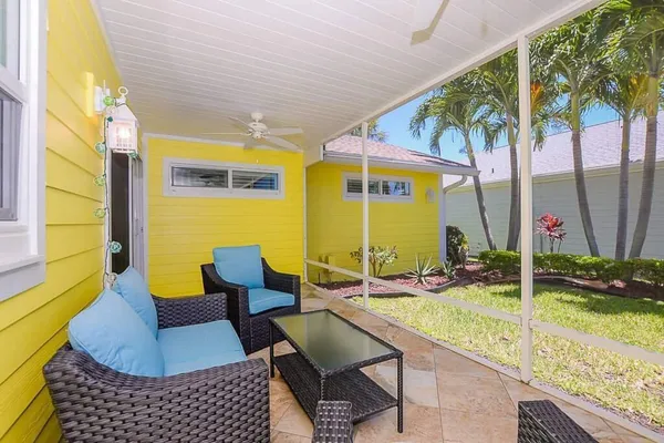 a backyard of a house with yard and outdoor seating