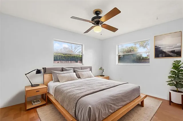 a bathroom with a granite countertop sink a toilet a mirror and shower
