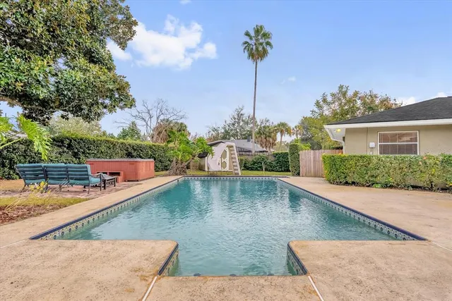 a view of house with garden space and sitting area