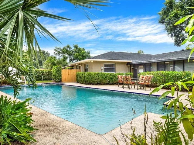 a front view of house and yard with swimming pool and porch