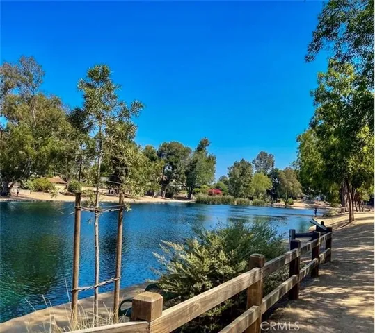 a view of a street with a cars park on the side of a road
