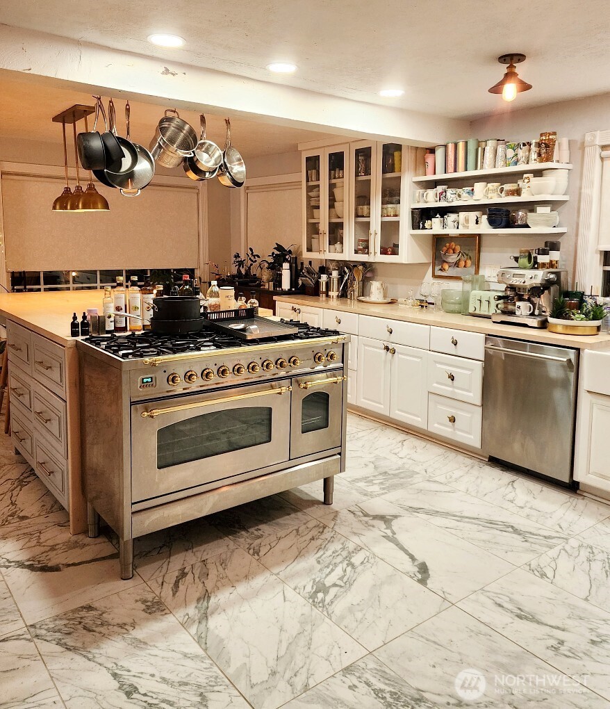 6217 Lackey Road Northwest Vaughn, WA 98394 - Photo 9 of 26 a kitchen with stainless steel appliances granite countertop a stove and cabinets
