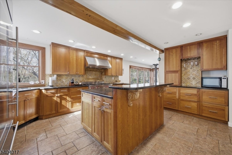 23 Lingert Avenue Clinton, NJ 08809 - Photo 2 of 43 a kitchen with stainless steel appliances granite countertop a refrigerator a sink dishwasher a stove with wooden cabinets and floor