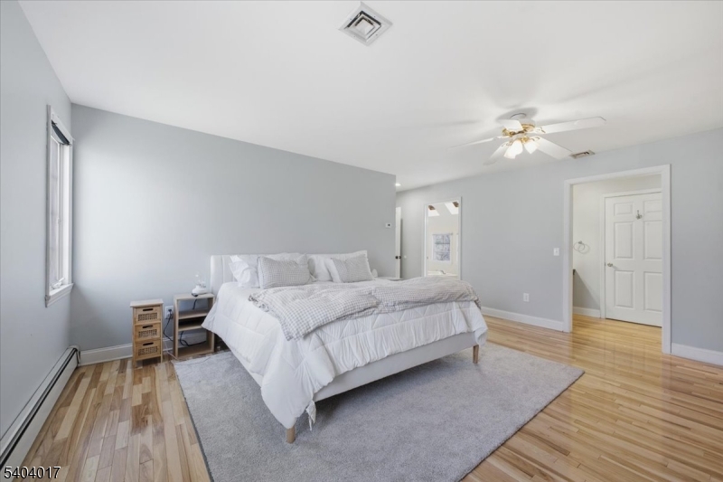 23 Lingert Avenue Clinton, NJ 08809 - Photo 24 of 43 a spacious bedroom with a bed and a chandelier