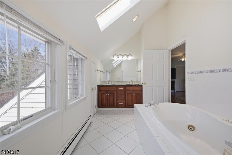 23 Lingert Avenue Clinton, NJ 08809 - Photo 26 of 43 a bathroom with a tub a sink and a large mirror