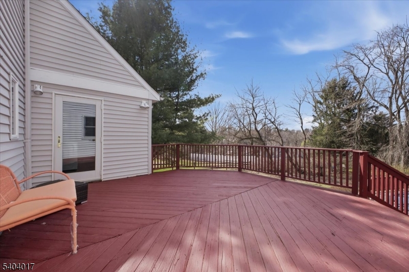23 Lingert Avenue Clinton, NJ 08809 - Photo 35 of 43 a view of a deck with wooden floor and fence with a floor to ceiling window